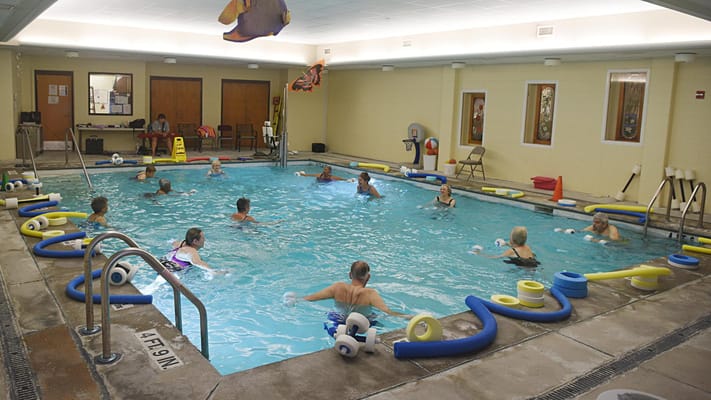 Residents participating in aquatic therapy in a pool