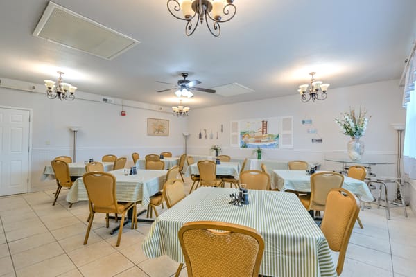 Bright dining room with tables set for meals