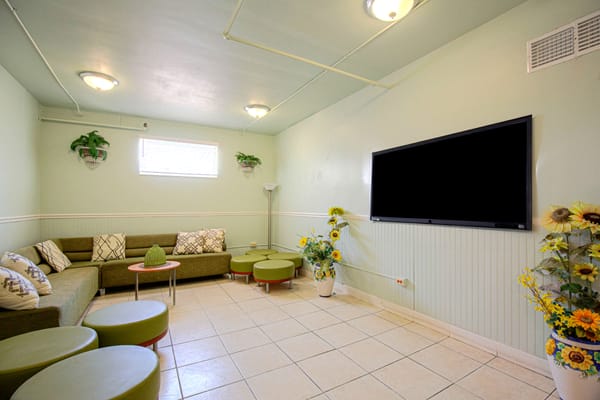 Bright and inviting common area with seating and TV