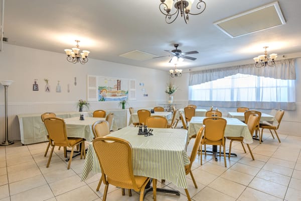 Dining area with tables and chairs for residents