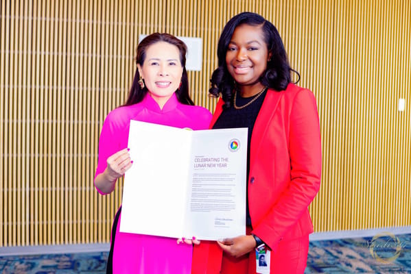 Two women celebrating Lunar New Year in an interior setting