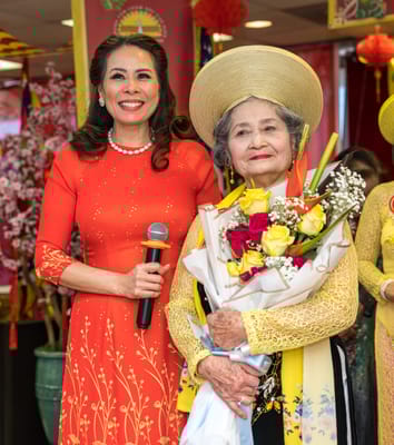 Celebration with a resident and staff member in traditional attire