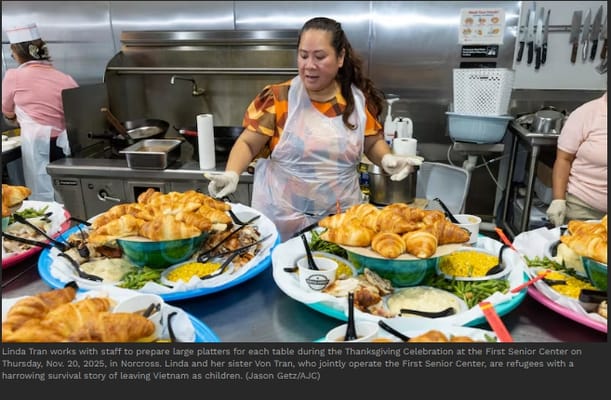 Staff serving food during a Thanksgiving celebration