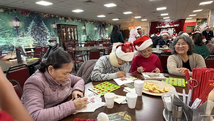 Residents engaged in a holiday activity at a festive common area