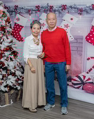 Residents posing together in front of a festive backdrop