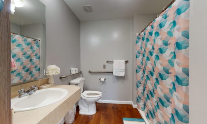 Clean and bright private bathroom with floral decor