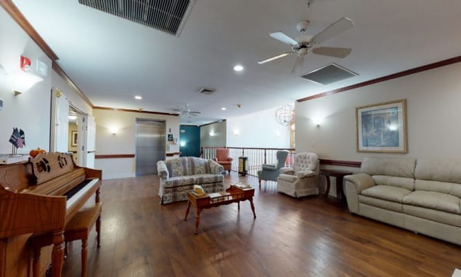 Common area with seating and piano in facility
