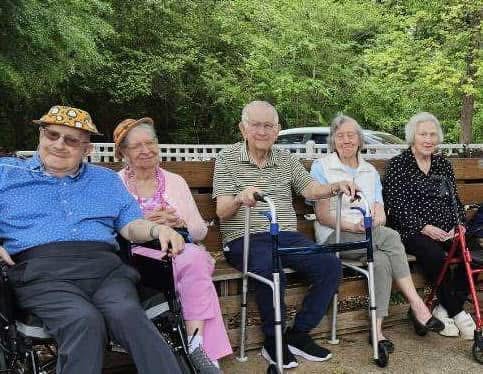 Residents enjoying time outdoors on a bench