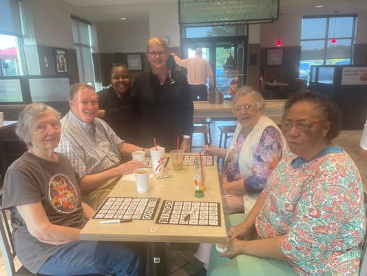Residents enjoying a bingo game in a common area