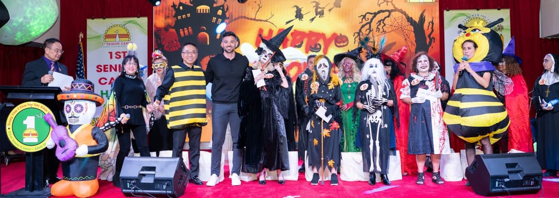 Residents and staff dressed in costumes at a Halloween celebration
