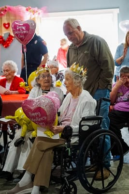 Residents celebrating Valentine's Day with decorations and balloons