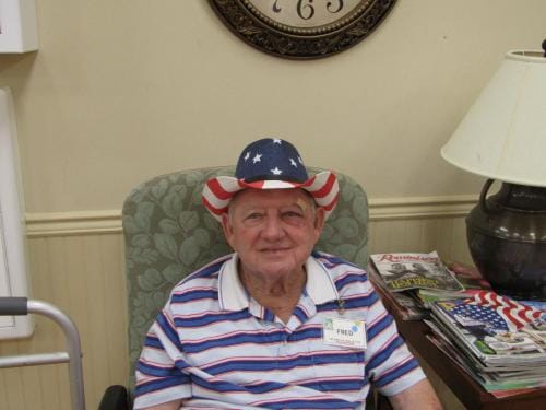 Resident wearing a patriotic hat in a cozy interior