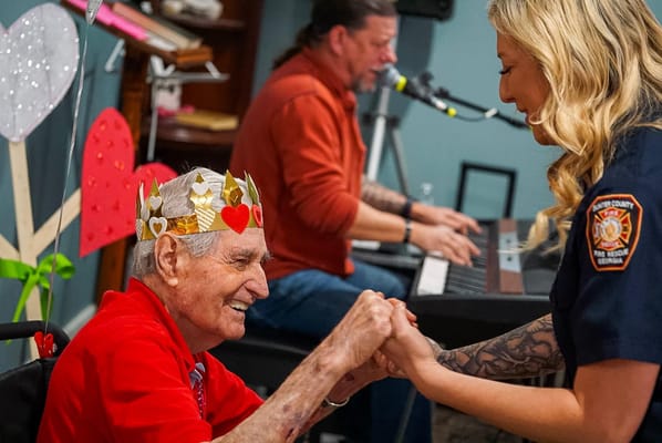 Resident participating in a music activity with staff
