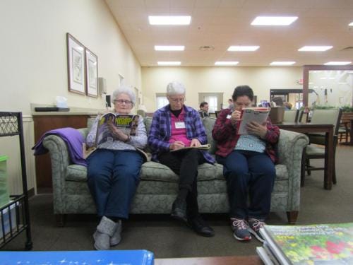 Residents reading magazines in a common area