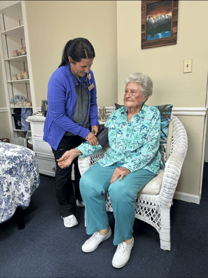 Staff assisting a resident in a cozy room