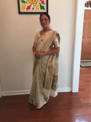 A resident dressed in traditional attire in a bright interior
