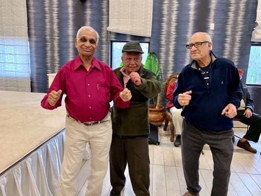 Residents enjoying a lively dance in an activity room