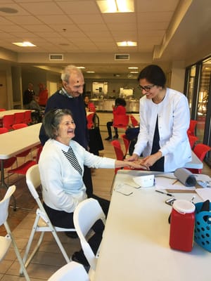 Resident receiving care from staff in a common area