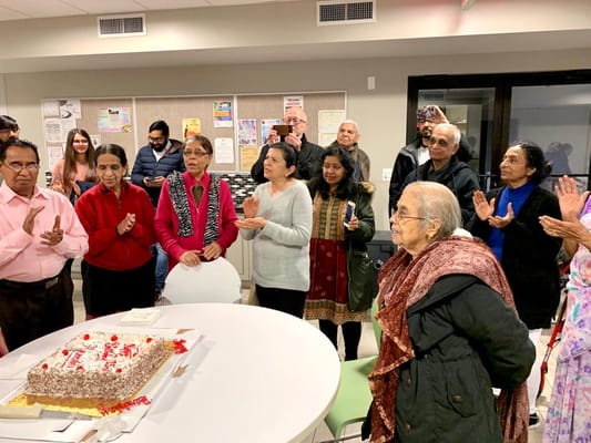 Residents celebrating with cake in a common area