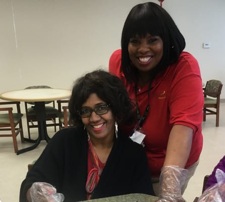 Staff member assisting a resident in an activity room