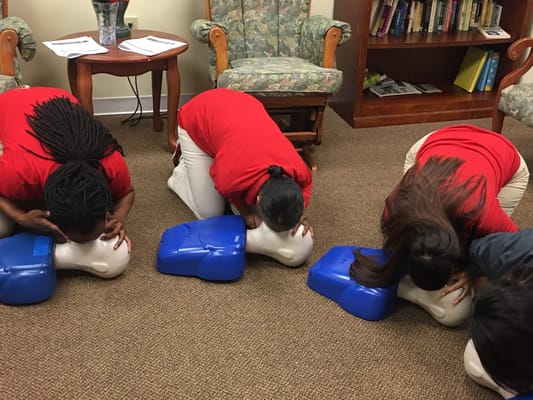 Staff performing CPR training in a common area