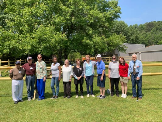 Residents and staff posing together in an outdoor area