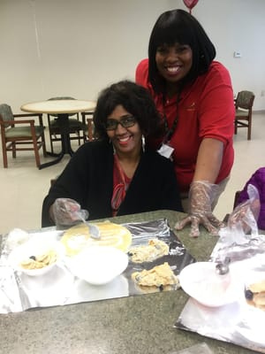 Staff and resident preparing food together