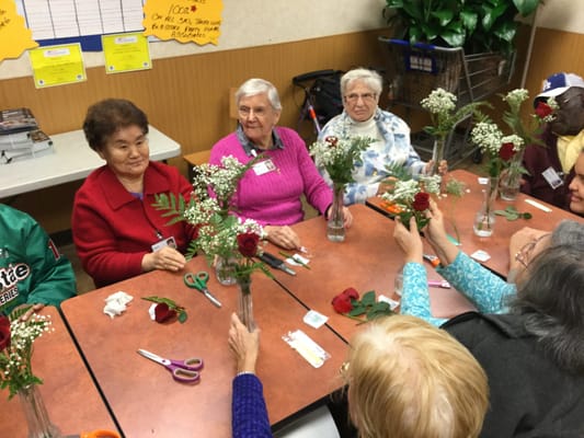 Residents arranging flowers in a common area