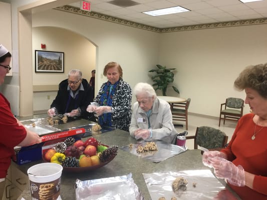 Residents participating in a baking activity in the common area