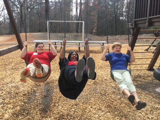 Residents enjoying swings in an outdoor area