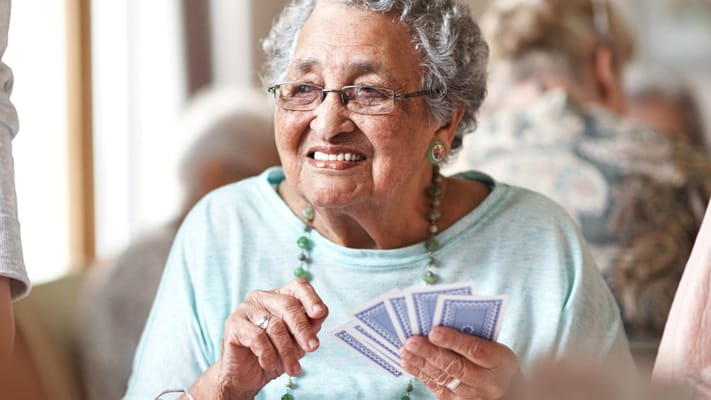 Resident playing cards with a joyful expression
