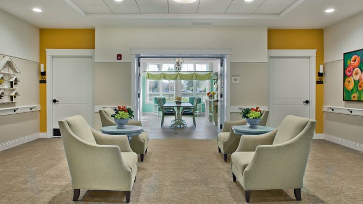 Bright common area with seating and floral decor