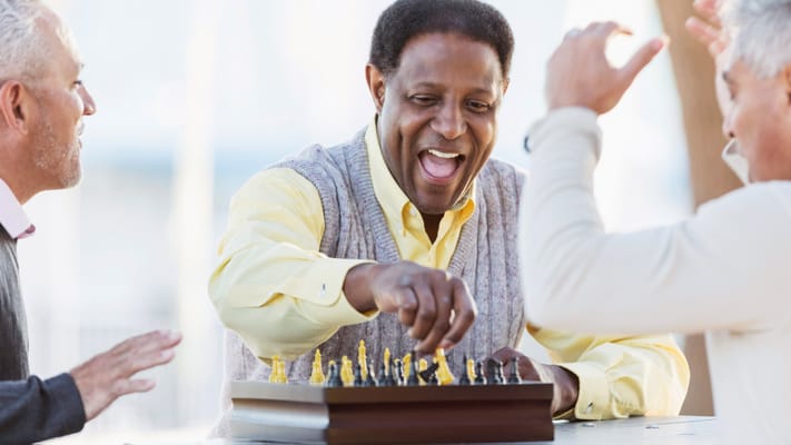 Residents enjoying a game of chess outdoors