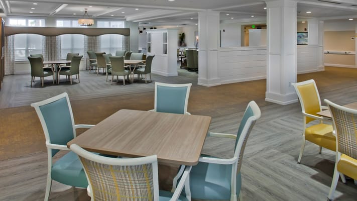 Bright and spacious common area with dining tables