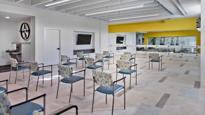 Bright activity room with chairs arranged for an event