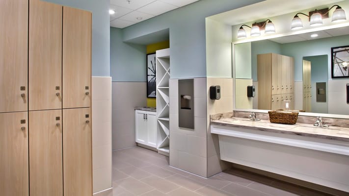 Modern restroom area with lockers and sinks