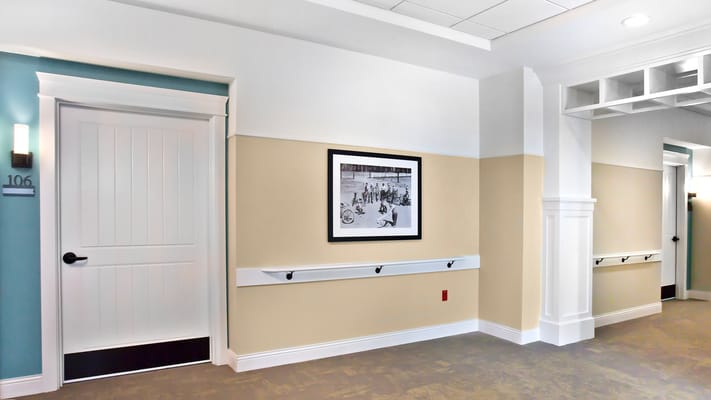 A well-lit hallway with a framed photo on the wall