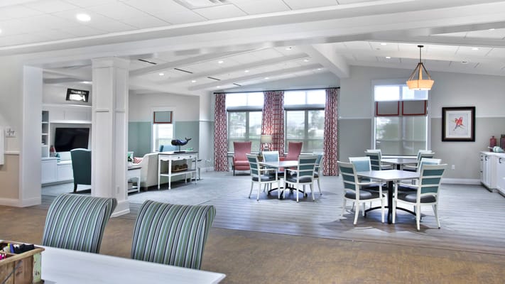 Bright common area with seating and dining tables