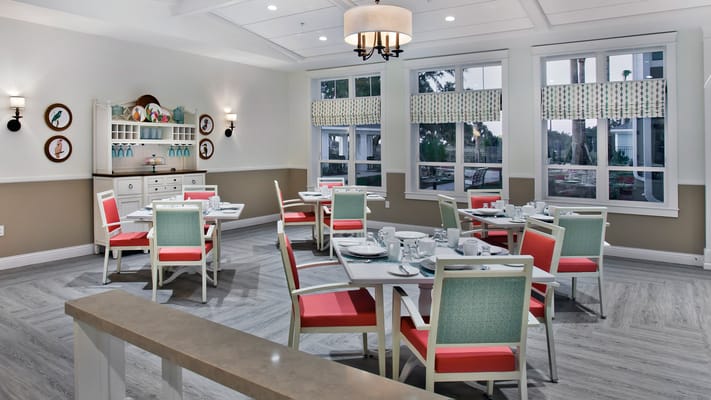 Bright dining room with tables set for meals