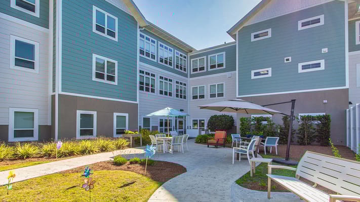 Outdoor courtyard with seating and shade umbrellas