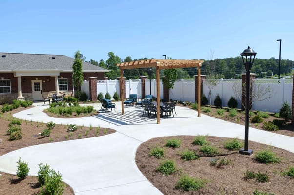 Outdoor seating area with pergola and pathways