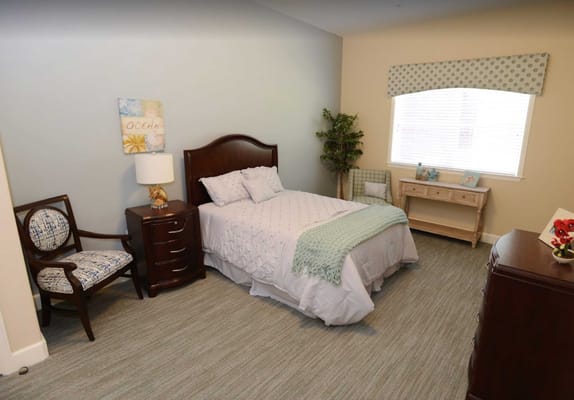 Interior view of a resident room with a bed and chair