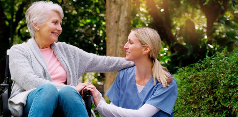 Caregiver interacting with a resident outdoors