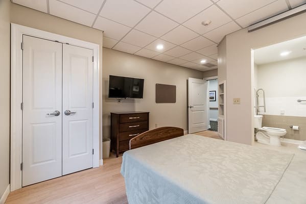 Cozy interior of a resident bedroom with TV and furniture