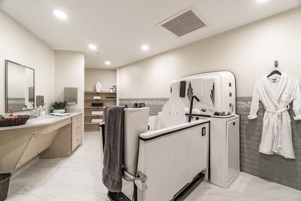 Modern bathroom with a therapeutic tub and robe
