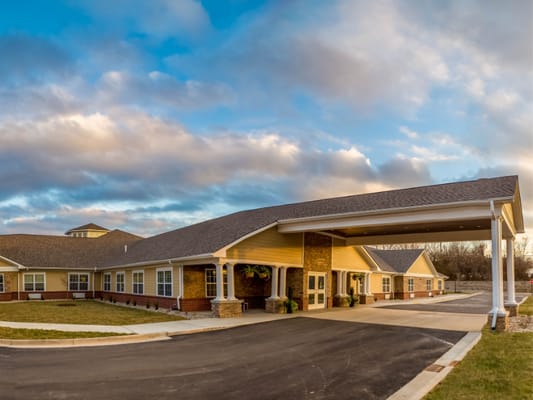 Exterior view of a senior living facility with covered entrance