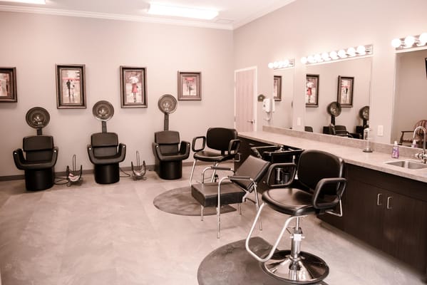 Hair salon area with styling chairs and equipment