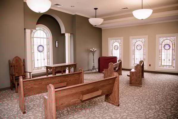 Interior room with wooden benches and stained glass windows