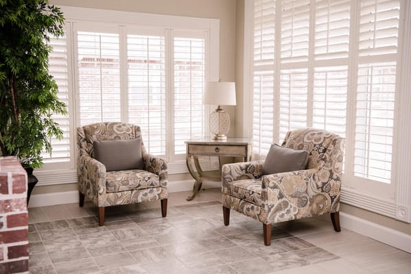 Cozy seating area with patterned chairs and a lamp