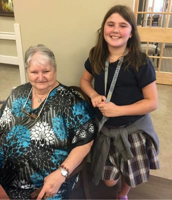 Resident and young visitor smiling together